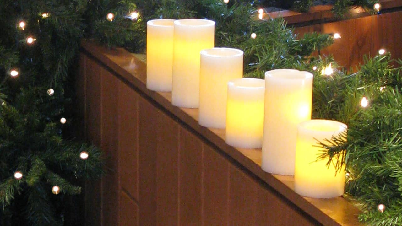 candles glow with greenery
